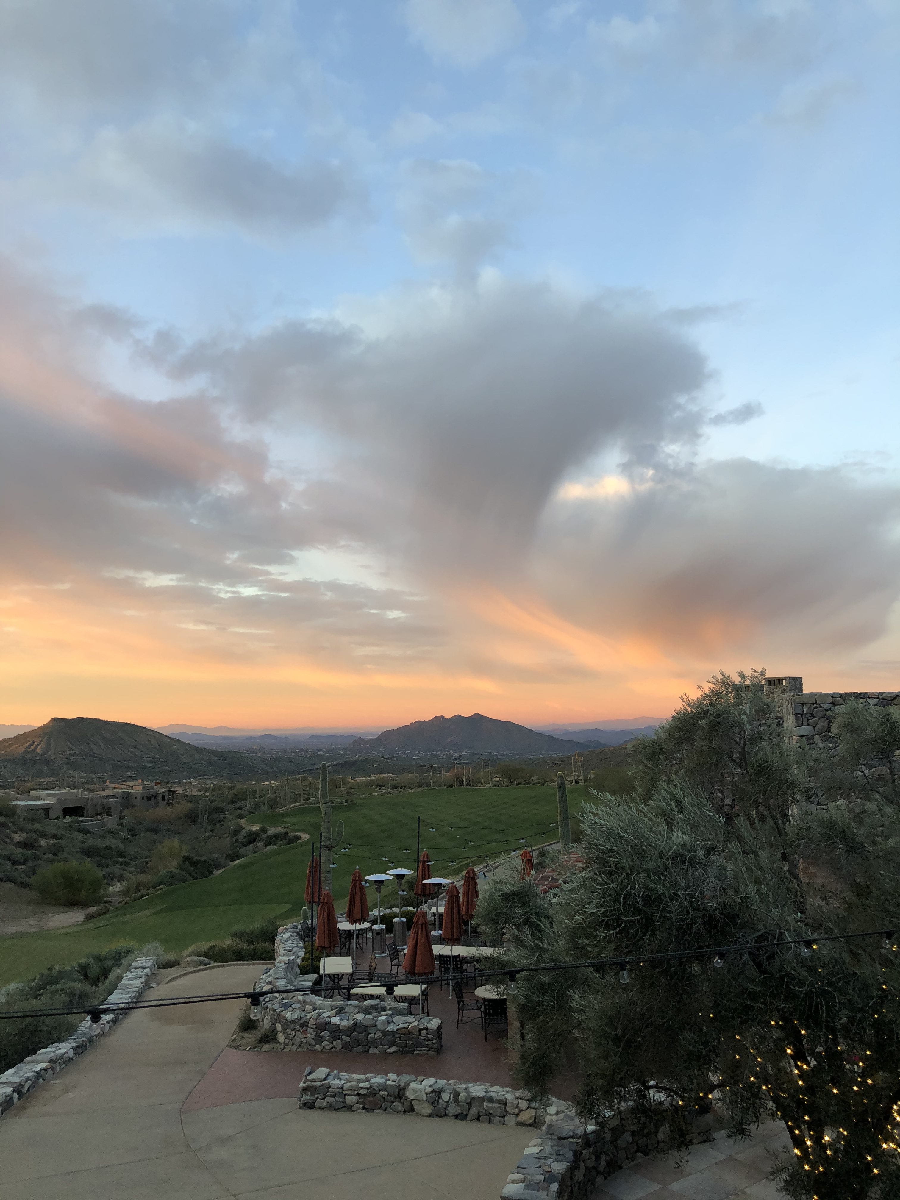 Clubhouse patio at sunset with mountain views at Desert Mountain